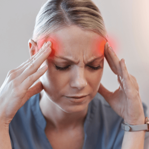 Person holding temples with highlighted pain indicating a tension-type headache.