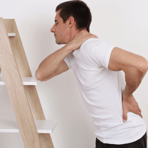 Man holding his neck and lower back indicating muscle spasms and pain.