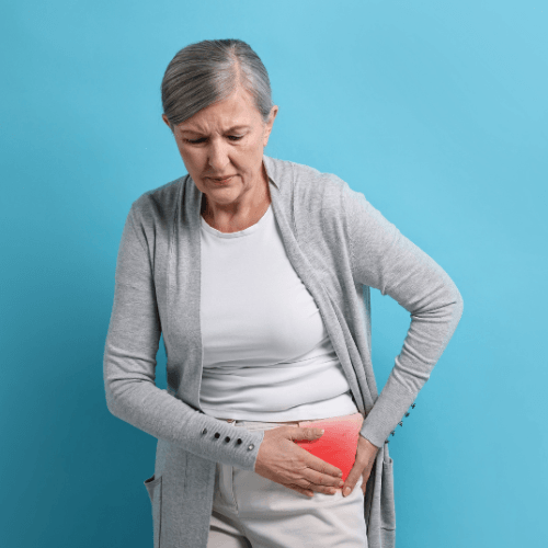Woman holding the front of her hip with highlighted pain indicating a hip flexor strain.