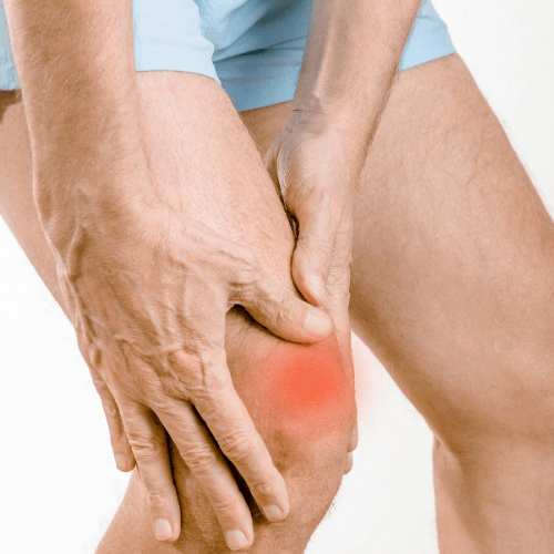 Person holding the front of the knee with highlighted pain below the kneecap indicating patellar tendinopathy.
