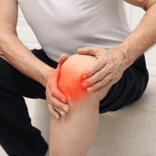 Person holding the front of the knee with highlighted pain indicating patellofemoral pain syndrome.