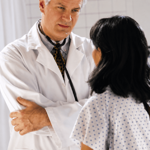 Physician discussing back surgery treatment options with a patient during a medical consultation.