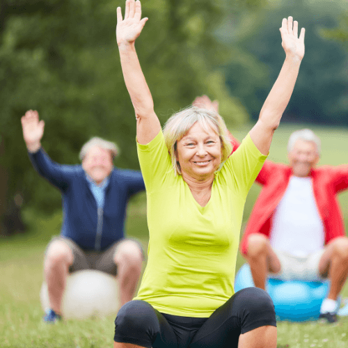 Older adults participating in an outdoor exercise class to improve strength, mobility, and back health.