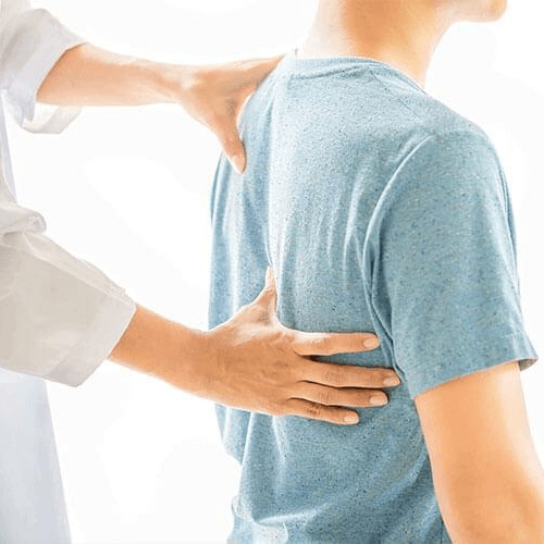 Chiropractor performing a thoracic spine adjustment on a patient to improve upper back mobility and spinal function.