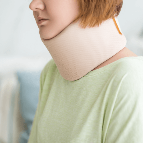 Person wearing a cervical neck brace for support following a whiplash neck injury.