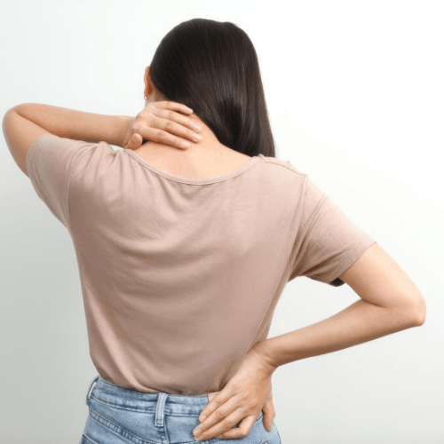 Woman holding her neck and lower back while experiencing spinal pain and stiffness, representing self-chiropractic adjustment concerns.