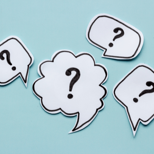 Paper speech bubbles with question marks on a light teal background